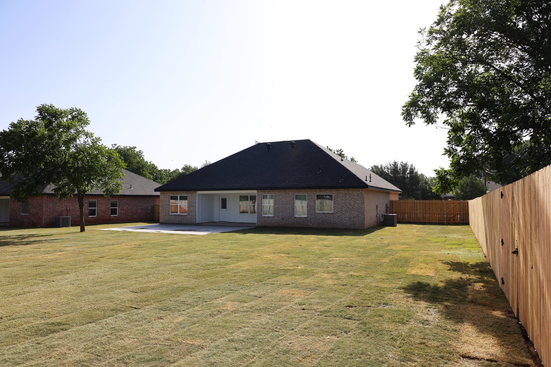 Finished rear exterior and covered patio at a Roadrunner custom home.